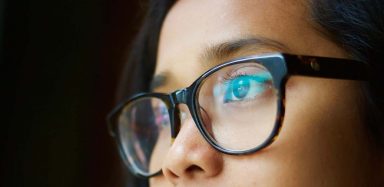 Someone wearing a pair of black-framed glasses.