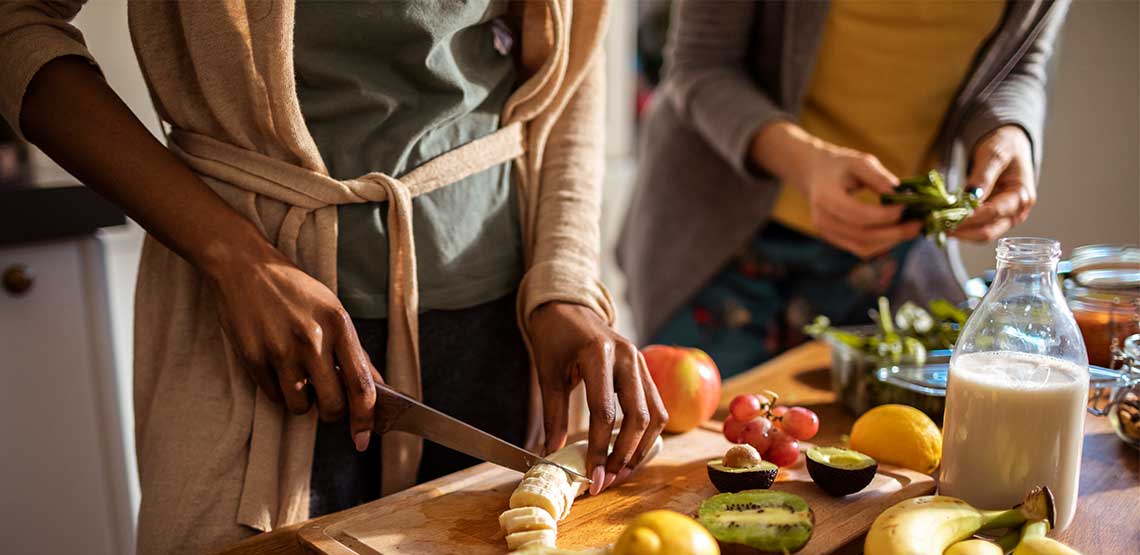 two women preparing a plant based diet meal