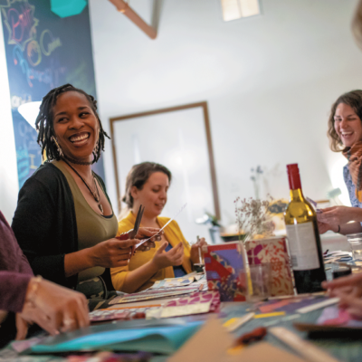 People at a table with wine at Maker Community.