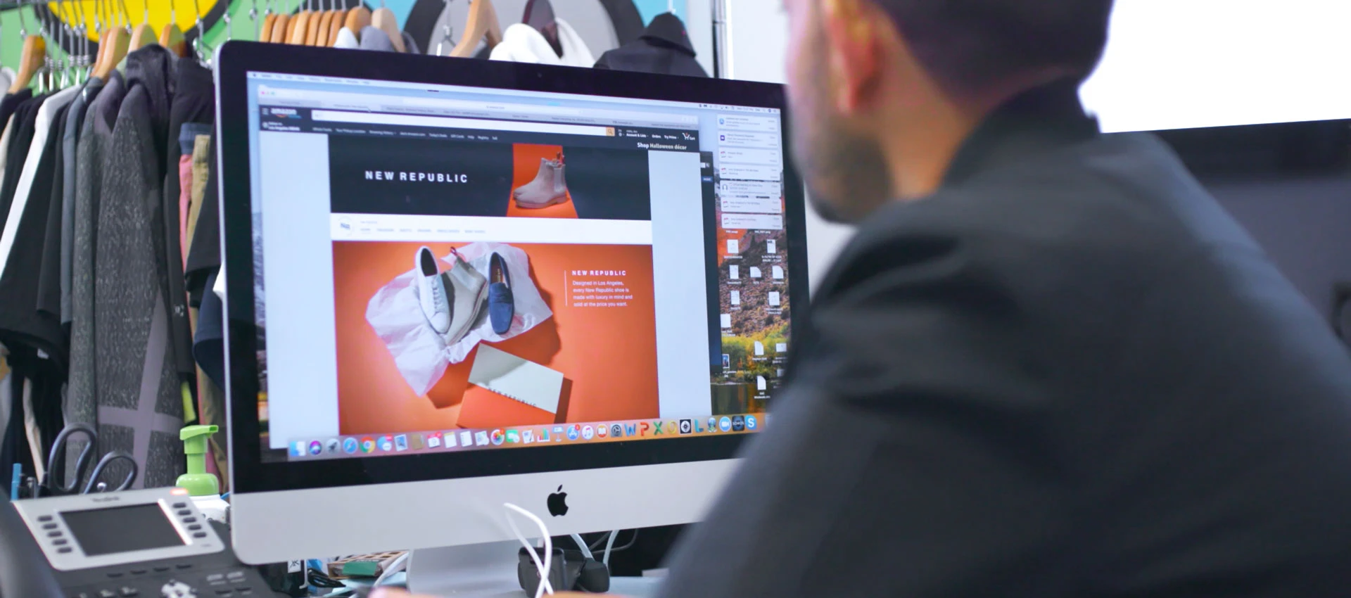 A man looking at a computer screen showing an online store on amazon.com for the fashion brand New Republic