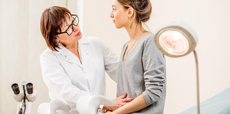 A female doctor is examining a female patient