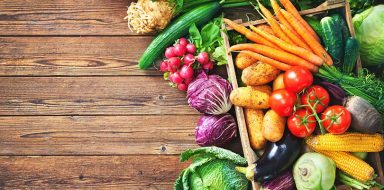 Assortment of the fresh vegetables on rustic wooden table