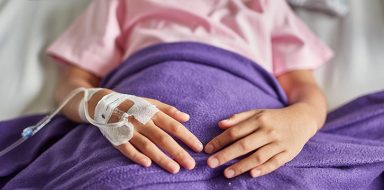 Close-up of patient receiving IV Drip medicine at hospital