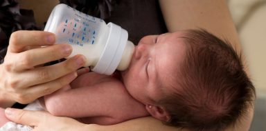 A mother feeding her child.